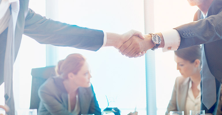 Our funding Photo of professionals shaking hands